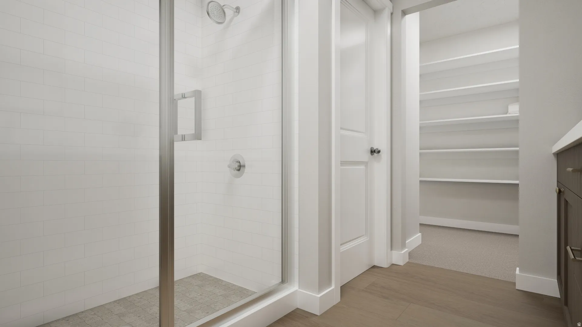 Glass-enclosed shower with subway tile surround, tiled shower floor, and brushed nickel fixtures