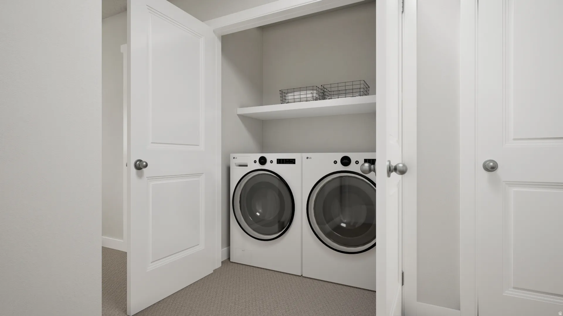 Laundry closet featuring a built-in shelf, and panel doors