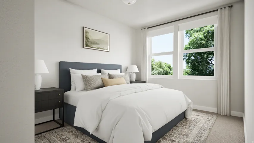 Bright room with dual windows, neutral wall tones, and carpeted flooring