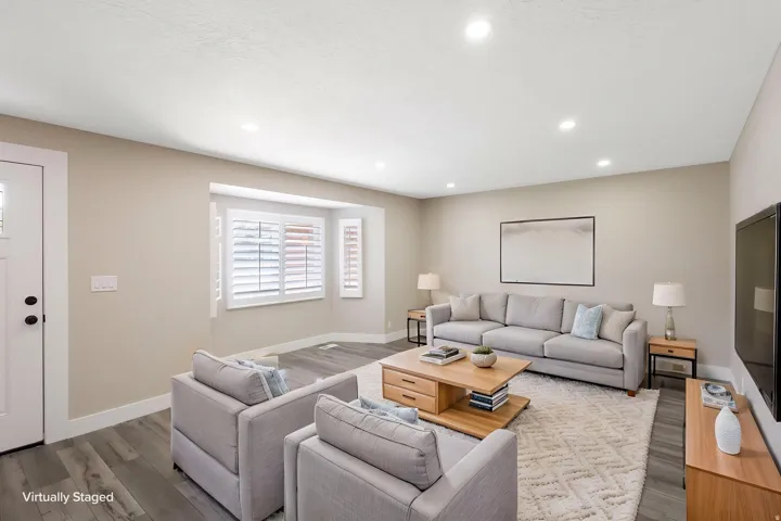 Recessed lighting, wood-finish flooring, white window shutters, and a bay window