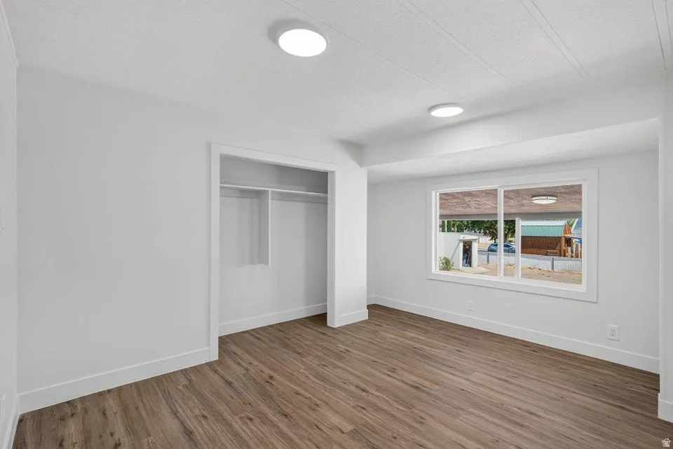 Recessed lighting, wood-finish flooring, and a built-in closet