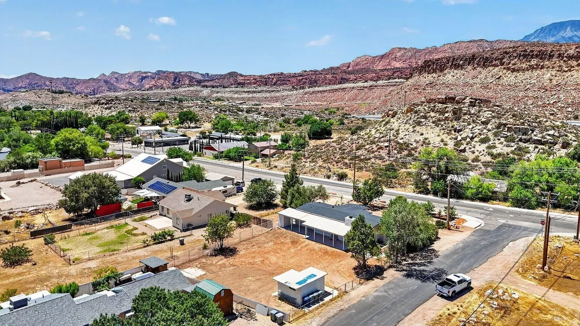 Expansive mountain scenery with residential properties and paved roadways