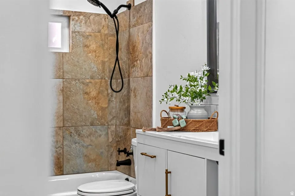 White vanity with brass hardware, undermount sink, and white countertop