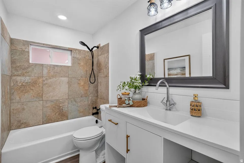 White vanity with gold-tone hardware, rectangular undermount sink, and chrome faucet