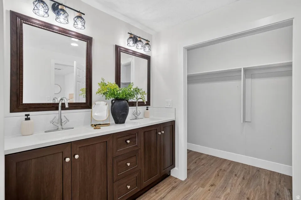 Dual vanity with wood-finish cabinetry and white countertops
