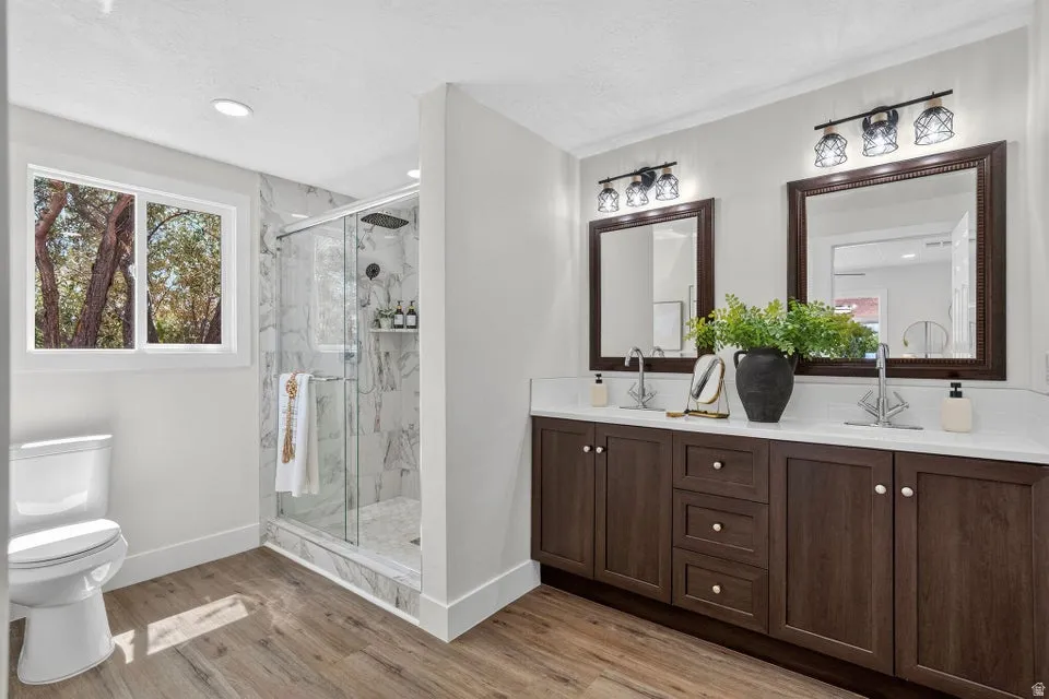 Dual vanity with dark wood-finish cabinetry and white countertops