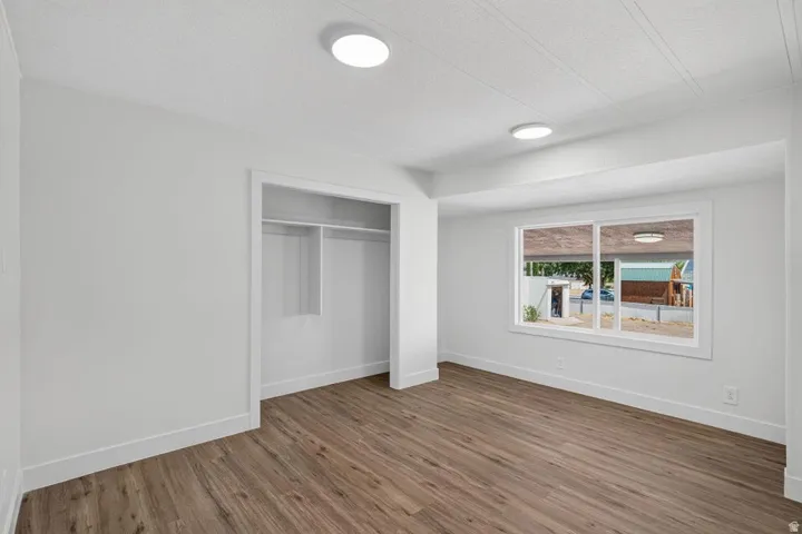 Recessed lighting, wood-finish flooring, and a built-in closet