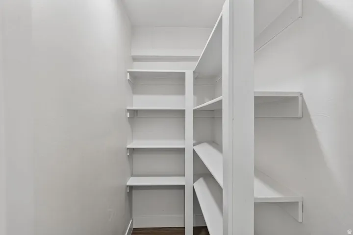 Integrated shelving system with multiple white shelves and white wall finishes