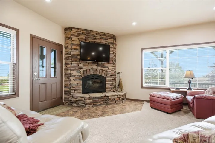 Corner stone-faced fireplace with hearth