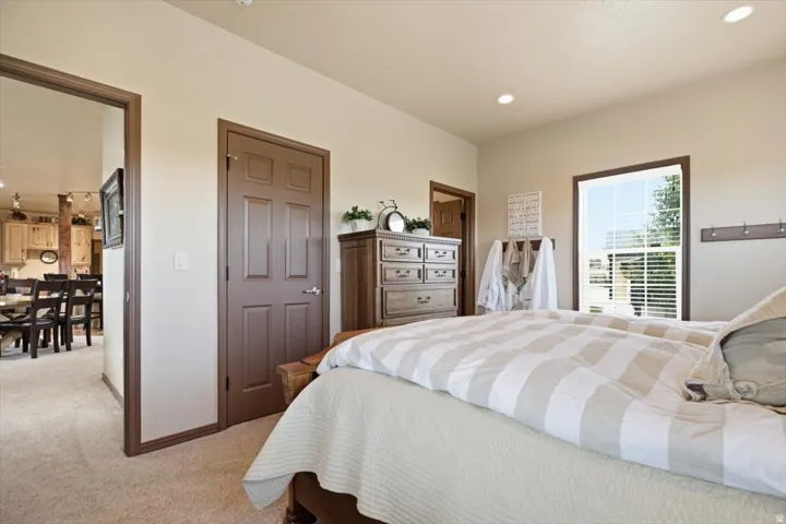 Plush carpet flooring, recessed lighting, and a window with blinds