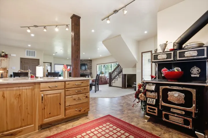 Kitchen island with light wood cabinetry and a light-colored countertop