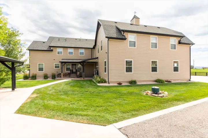 Expansive exterior with light-colored siding and dark trim