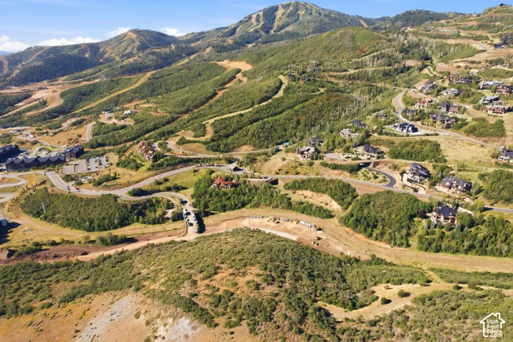 Mountainous terrain featuring developed residential areas, extensive paved roadways, and a prominent ski resort backdrop