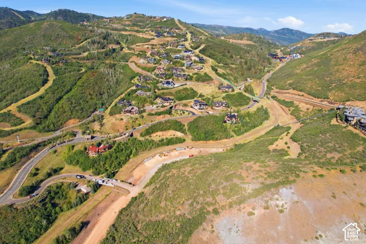 Expansive mountain landscape featuring varied terrain and numerous custom residences