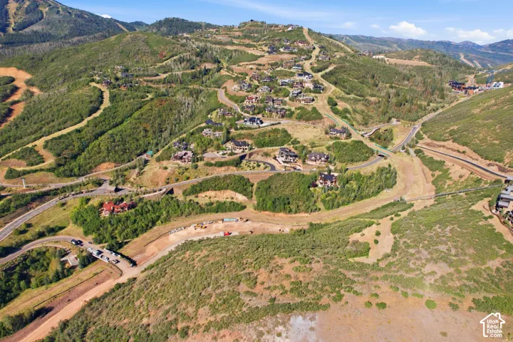 Mountainous terrain featuring developed residential areas, extensive green landscaping, and established roadways