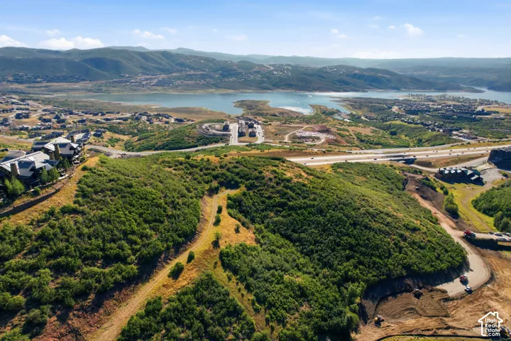 Expansive land parcel with surrounding residential development and distant water feature
