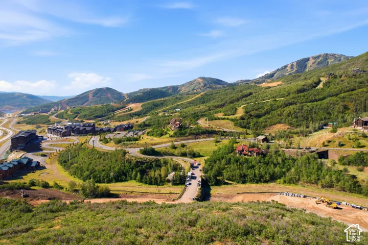 Expansive mountainous terrain with multiple structures and winding roads
