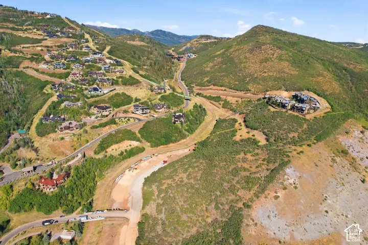 Elevated hillside properties with established residential structures and ongoing development