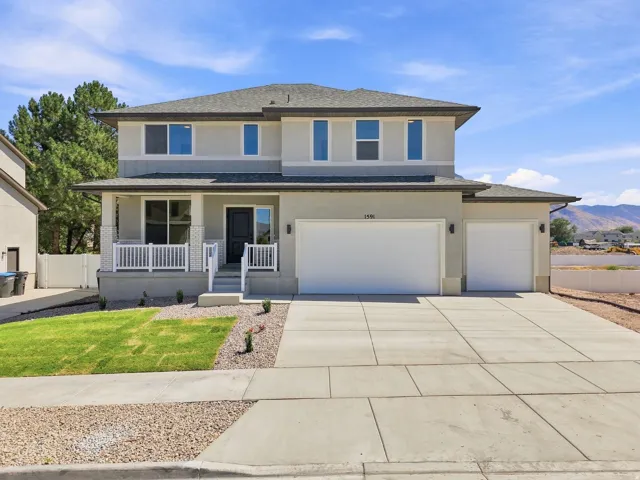 Two-story exterior with a covered porch, white railing, and a multi-car driveway