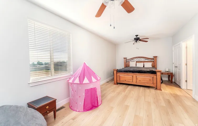 Recessed lighting, wood-finish flooring, and white walls