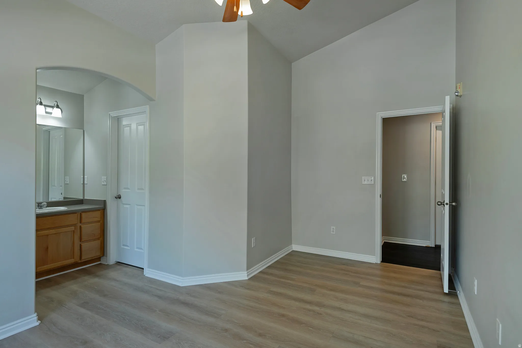 Vaulted ceilings and wood-finish flooring complement the neutral wall tones