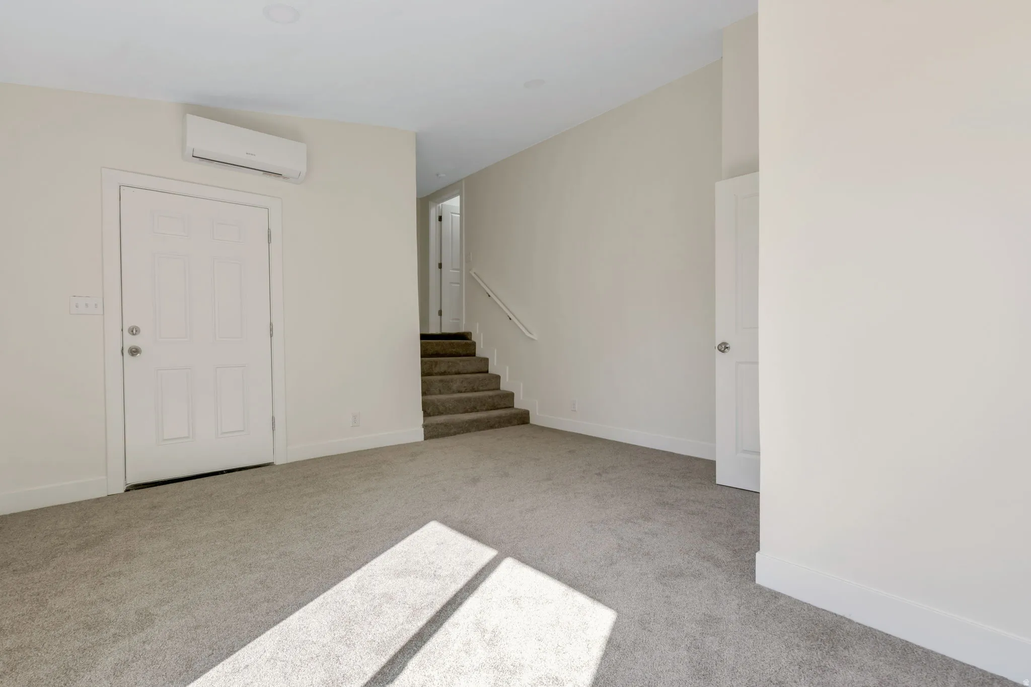 Bedroom 3 - Carpeted flooring, white walls, white trim, recessed lighting, and a minisplit-system air conditioning unit