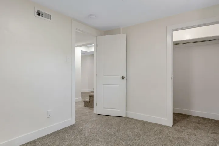 Bedroom 4 - Neutral-toned carpeting, white walls, and white trim