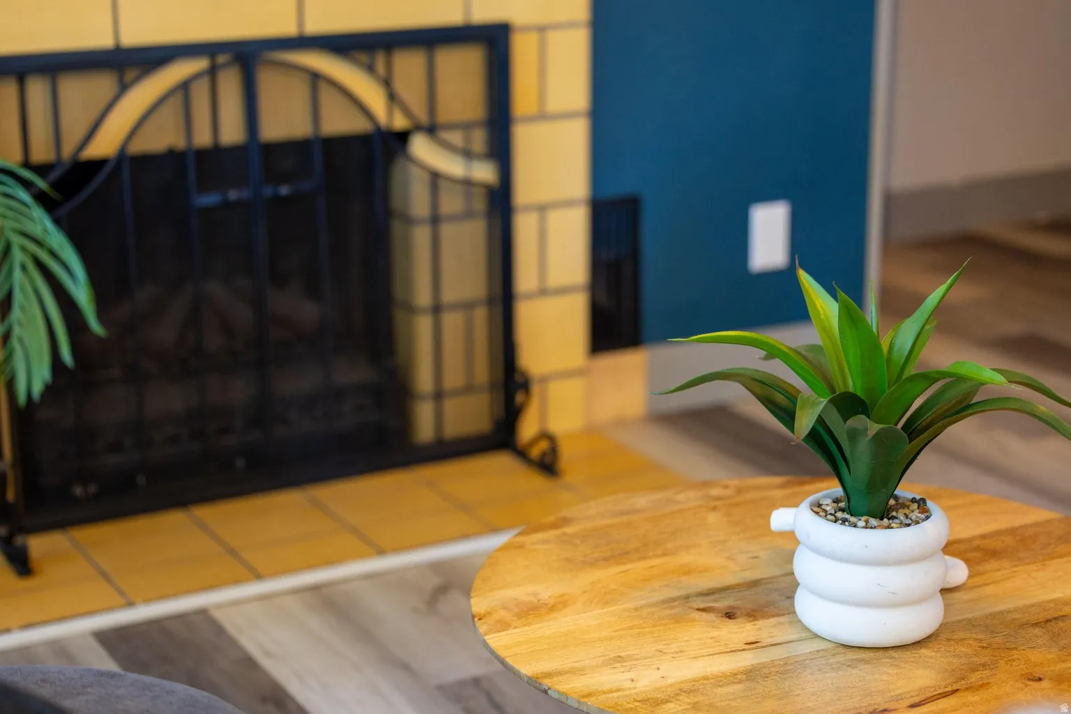 Fireplace featuring a decorative screen and yellow tile surround