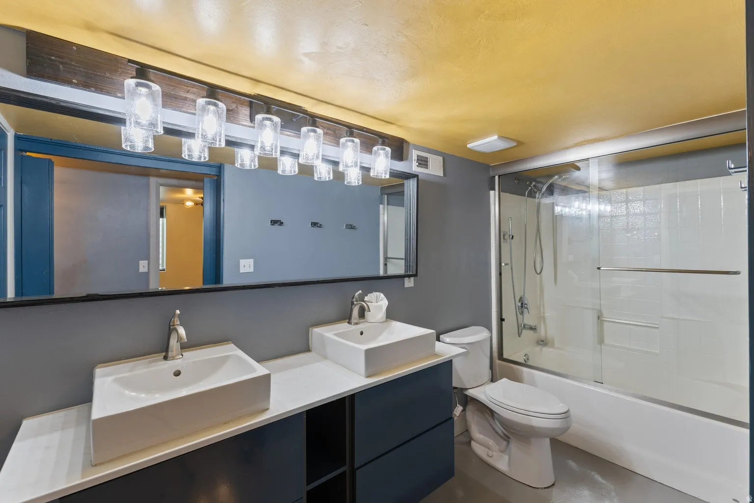 Dual vessel sinks set on a vanity with integrated storage