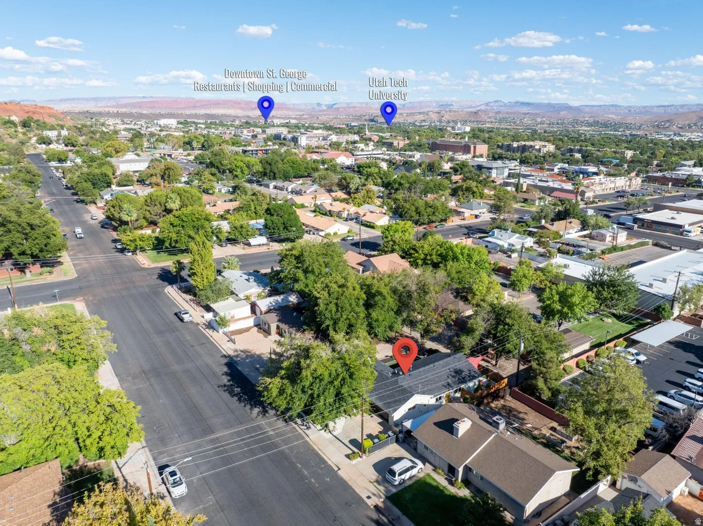 Aerial perspective displaying residential properties, mature trees, and paved roads