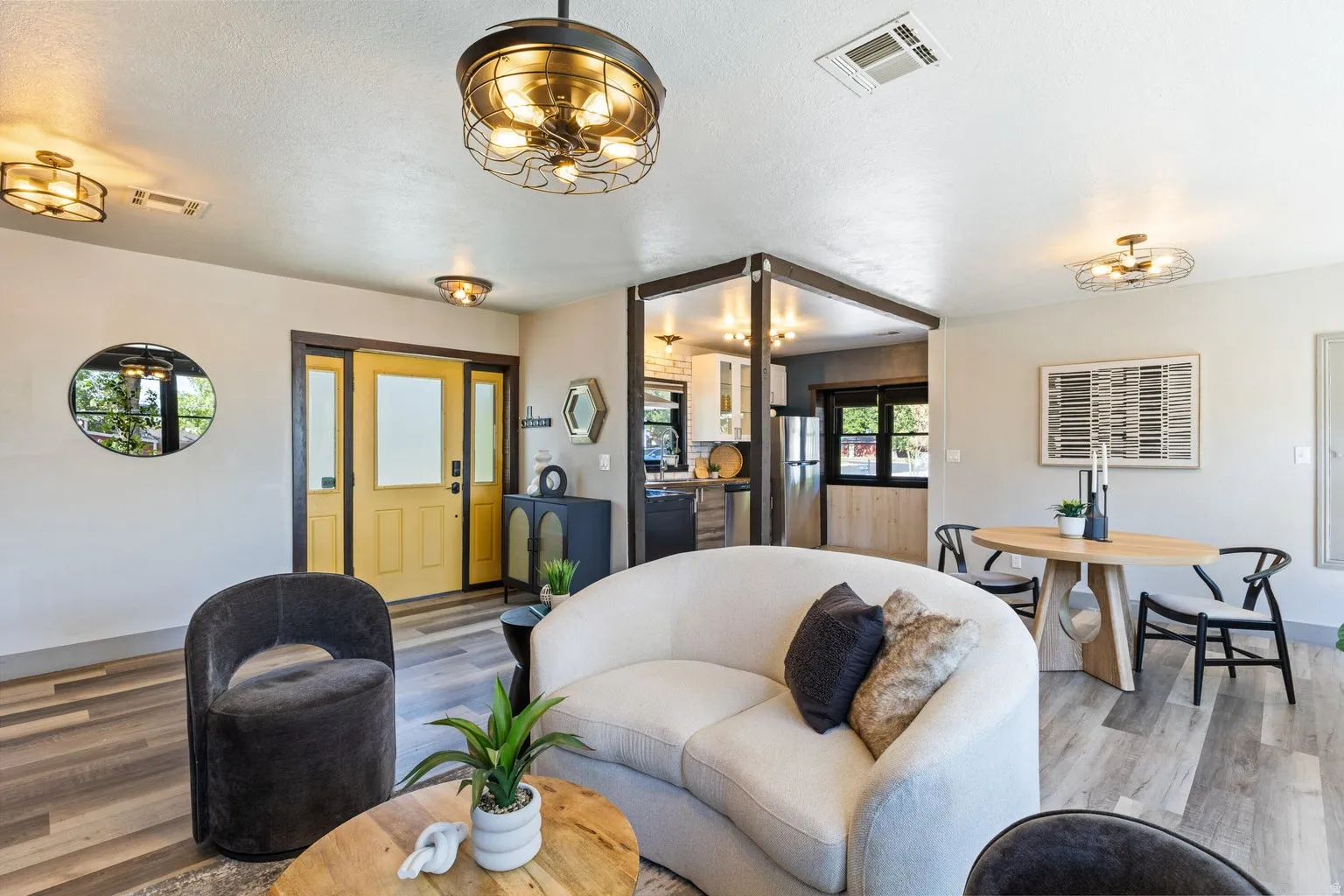 Recessed lighting, wood-finish flooring, and a decorative front door