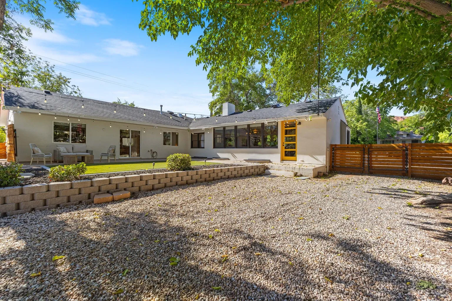 White stucco exterior with a dark shingle roof