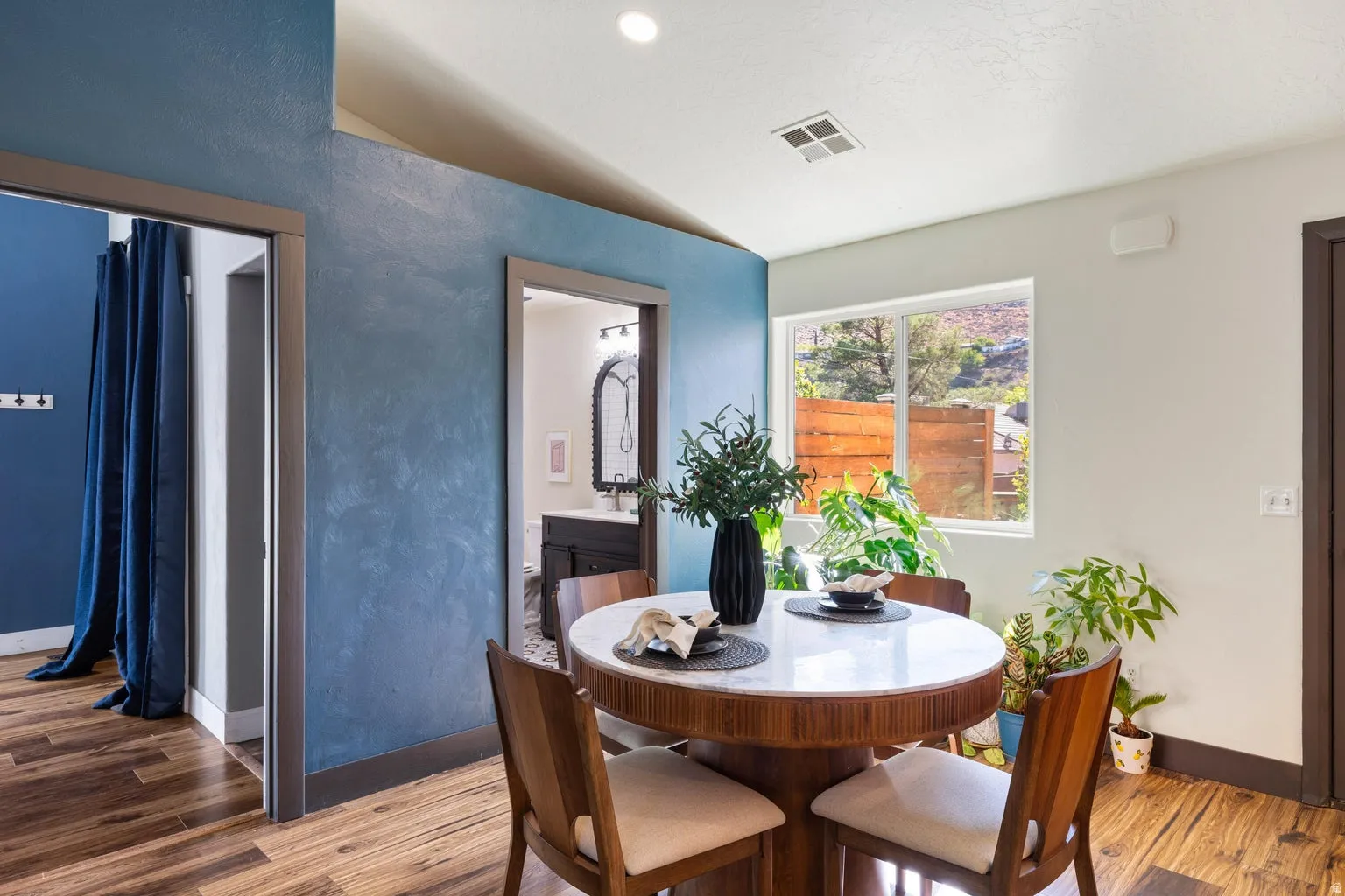 Wood-finish flooring with accent walls and recessed lighting