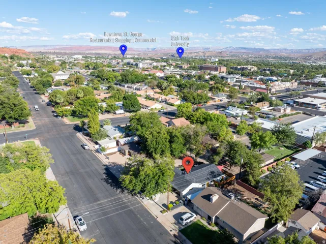 Aerial perspective displaying residential properties, mature trees, and paved roads