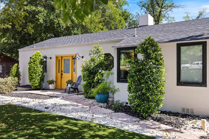 White stucco exterior with a dark shingle roof