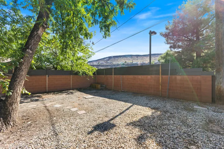 Enclosed yard space with a combination brick and privacy panel fence