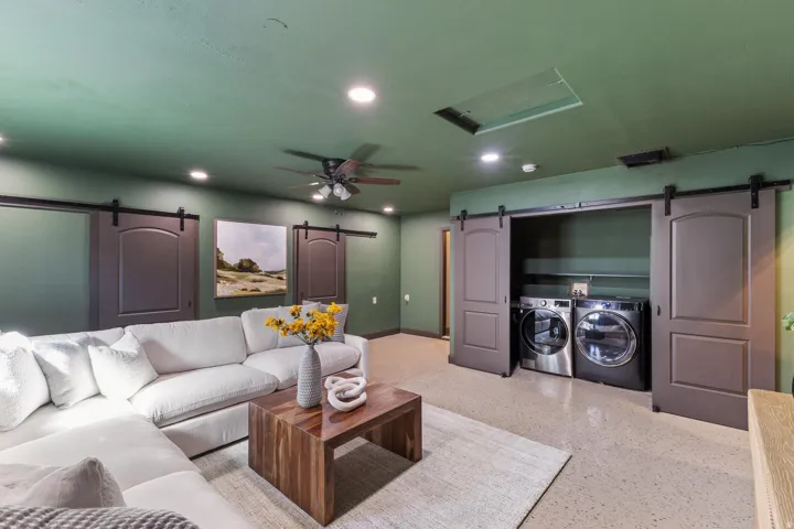 Recessed lighting, ceiling fan, barn doors, built-in laundry appliances, and speckled flooring