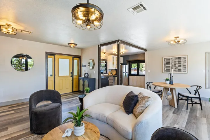 Recessed lighting, wood-finish flooring, and a decorative front door