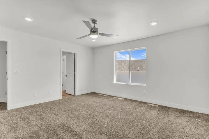 Recessed lighting, ceiling fan with integrated light, carpeted flooring, white walls, and white trim