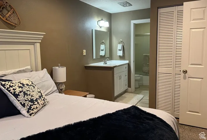 Integrated vanity with a single basin sink, wall-mounted mirror, and overhead light fixture