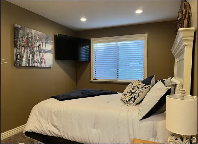 Recessed ceiling lighting, window with blinds, and white trim accents
