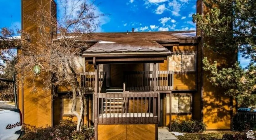 Multi-level exterior with wood siding and a covered entry
