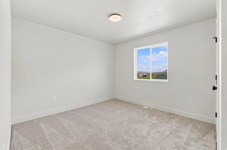 Light-toned wall finishes with a ceiling-mounted light fixture