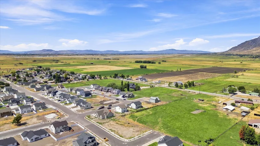 Expansive landscape featuring distant mountains and open fields
