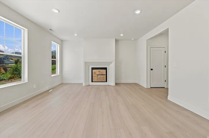 Recessed lighting and wood-finish flooring complement the white walls