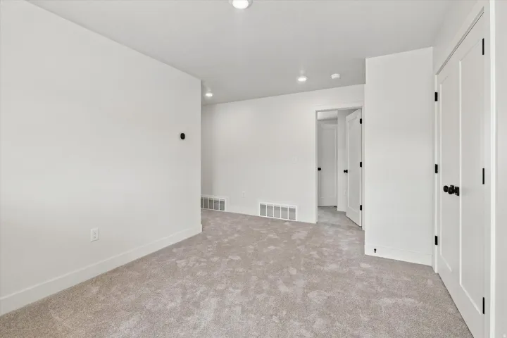 Neutral tone carpeting and white walls