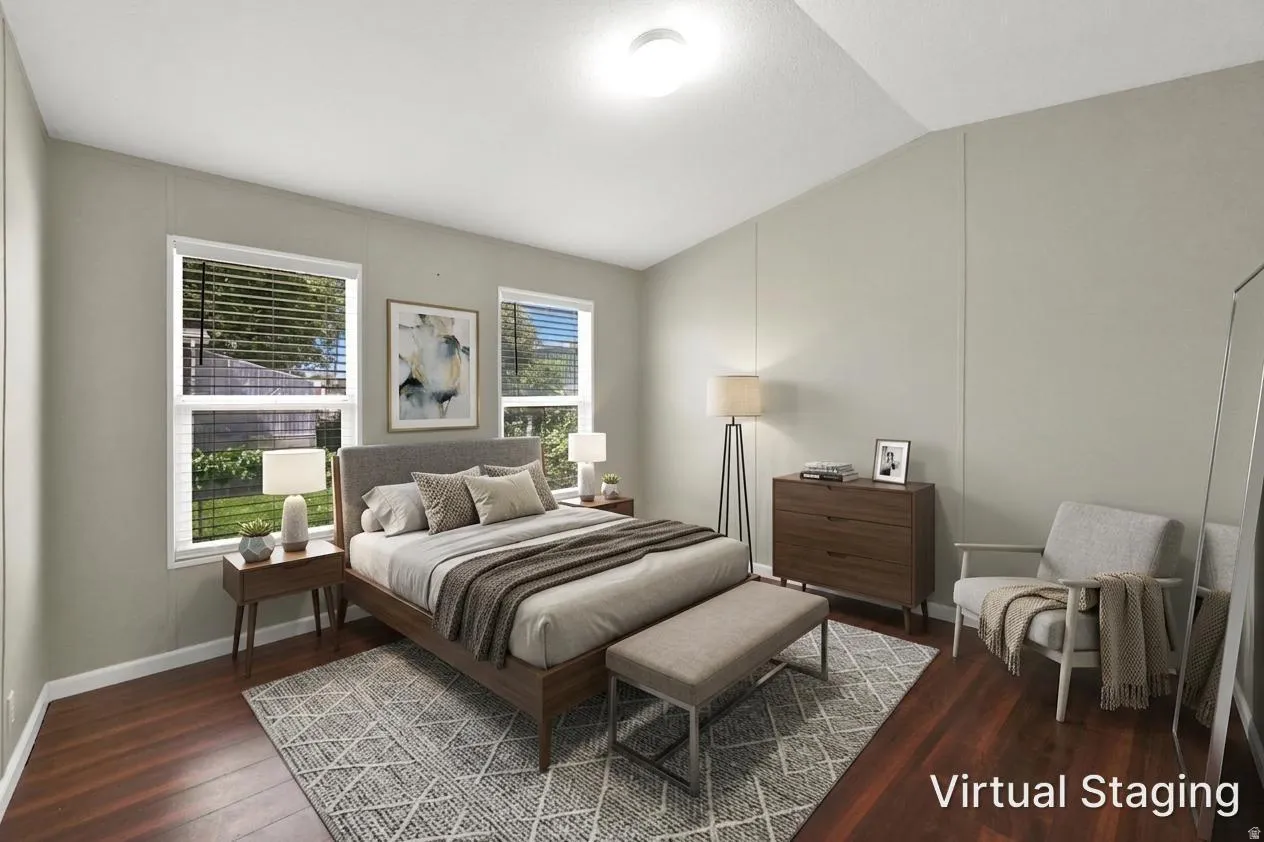 Hardwood-look flooring, ceiling-mounted light fixture, two windows with blinds, and light-toned walls