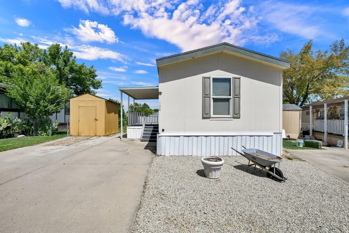 White vertical siding exterior with gray window shutters