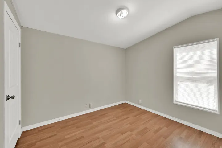 Neutral wall color, wood-finish flooring, and white trim