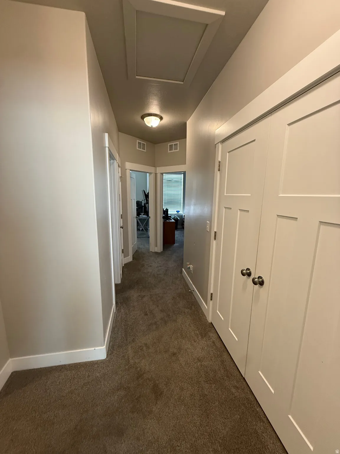Neutral wall paint with white trim, recessed lighting, and carpet flooring